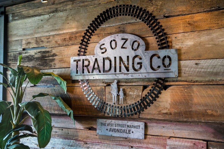 Sozo Trading Company sign on wall