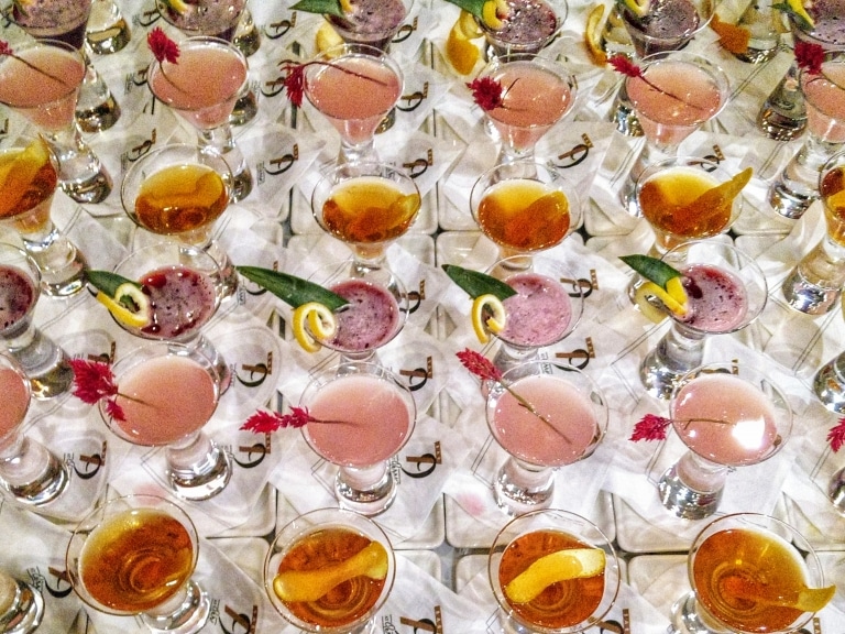 table full of brightly colored cocktails