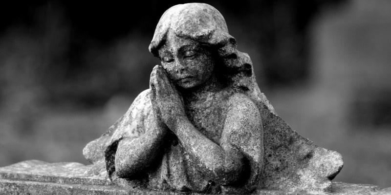 Gravestone angel praying in a piece on holiday depression in Birmingham. And, a Blue Christmas service.