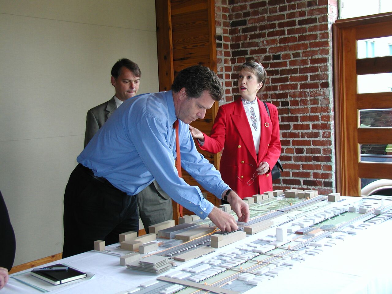 Giles and others looking at an early model of Railroad Park. 