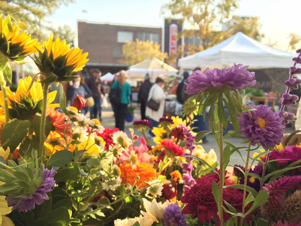 A view of Market at Pepper Place through a bevy of fresh flower bouquets