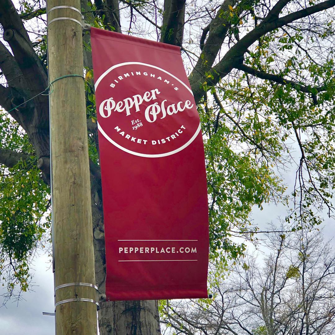 Photo shows a red banner that reads Birmingham's Pepper Place Entertainment District established 1988