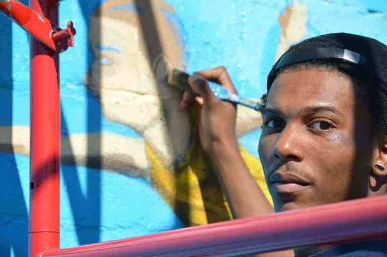Thurston Hamby is one of three artists from Blank Space Bham who painted "The Sky's the Limit," a new-ish mural in Woodlawn. 