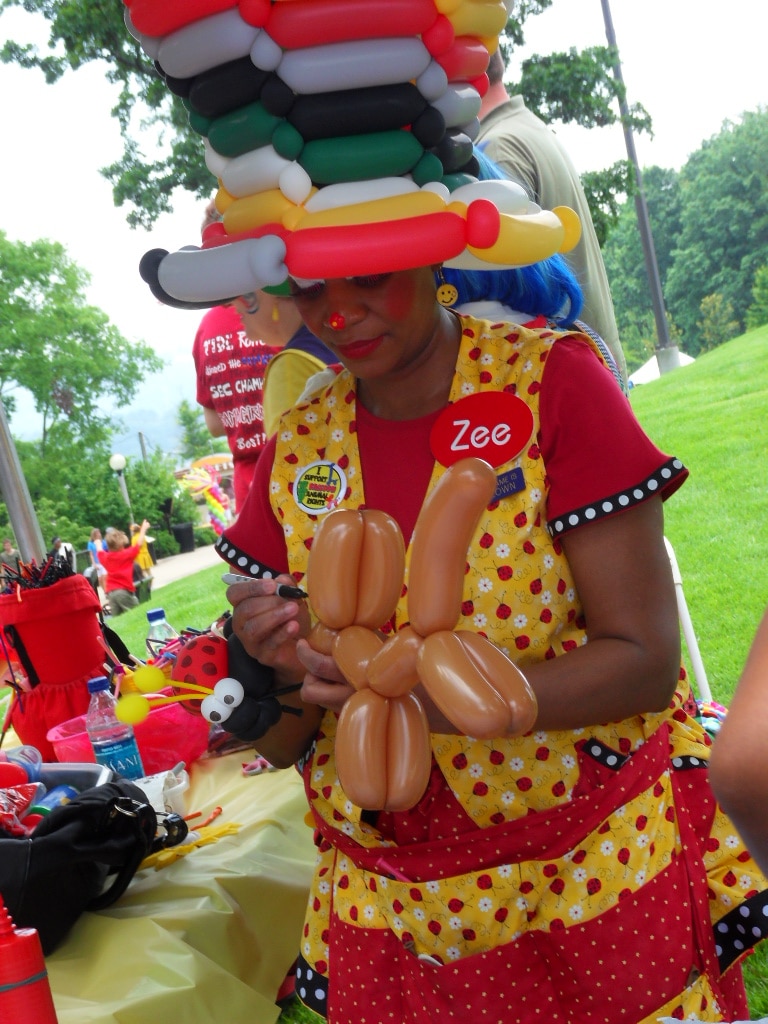 Clown making balloon animals at Vulcan Park's Birthday Bash