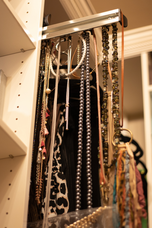 There are spots for costume jewelry in this designer closet by Closets by Design. 