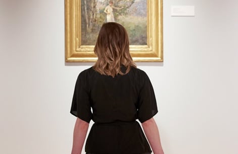 Woman looking at art