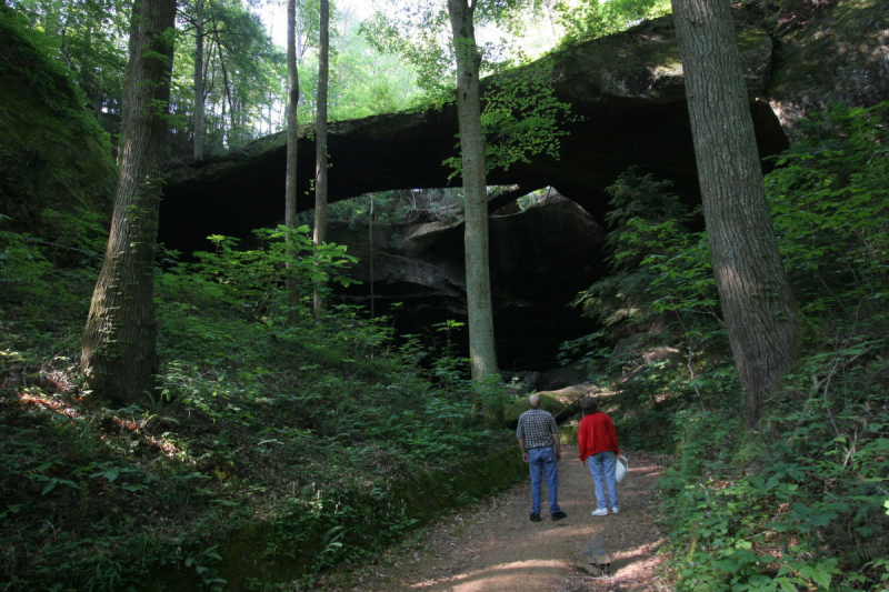 A man and woman looking at The Natural Bridge of Alabama in Winston County