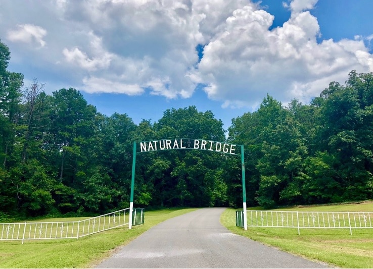 Sign above road. Road Trip to Natural Bridge of Alabama