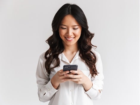 Woman smiling and looking at cell phone