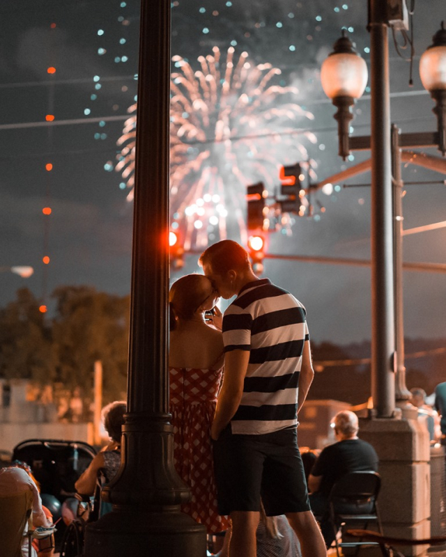 Couple kiss under fireworks