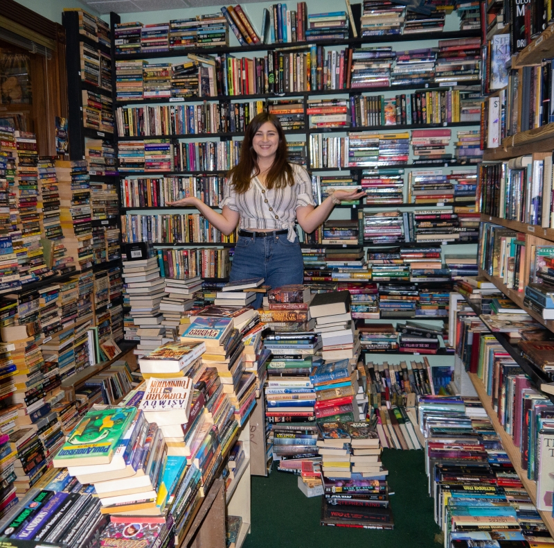 Girl Stands in Room of Books