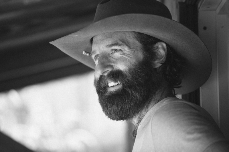 Man Smiles in a Cowboy Hat