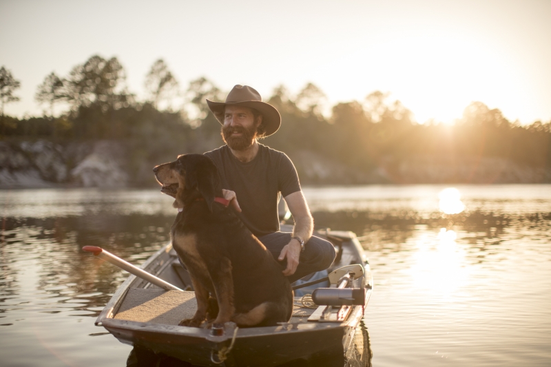 Man and Dog in Boat