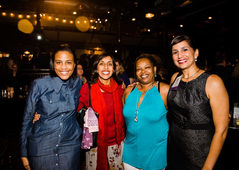 Four women smile and pose together at Smart Party 2018. 