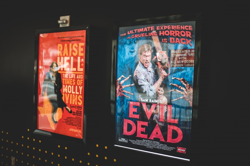 Two different movie posters are shown on the wall.