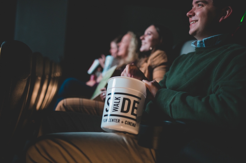 3 things you may not know about Birmingham's Sidewalk Film Center & Cinema at The Pizitz (GIVEAWAY) 2 The same four members are still seated in the theater, but the focus is on a bucket of popcorn.
