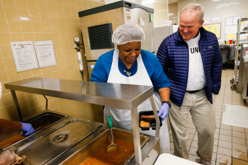 Two people volunteer in the Meals on Wheels kitchen