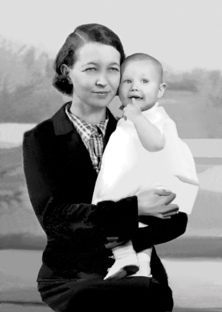 A restored version of an old photo. It depicts a woman holding a child.