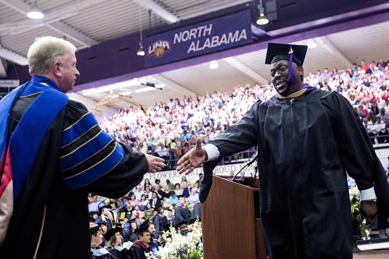 Dean Carnes with a UNA graduate at the UNA College of Business and Technology graduation.