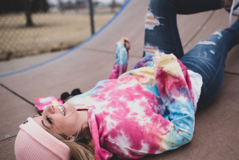 girl in pink and white striped long sleeve shirt lying on ground