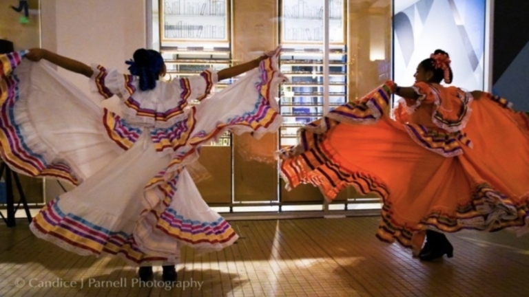 Photo of Latina dancers in traditional dresses