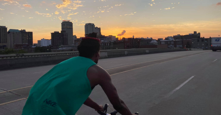 Bikers biking in front of Birmingham city view