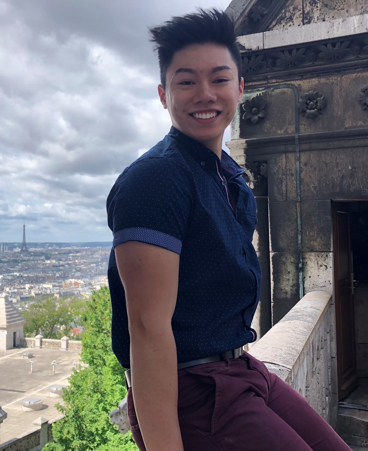 Andy Cao smiling at the camera from Paris