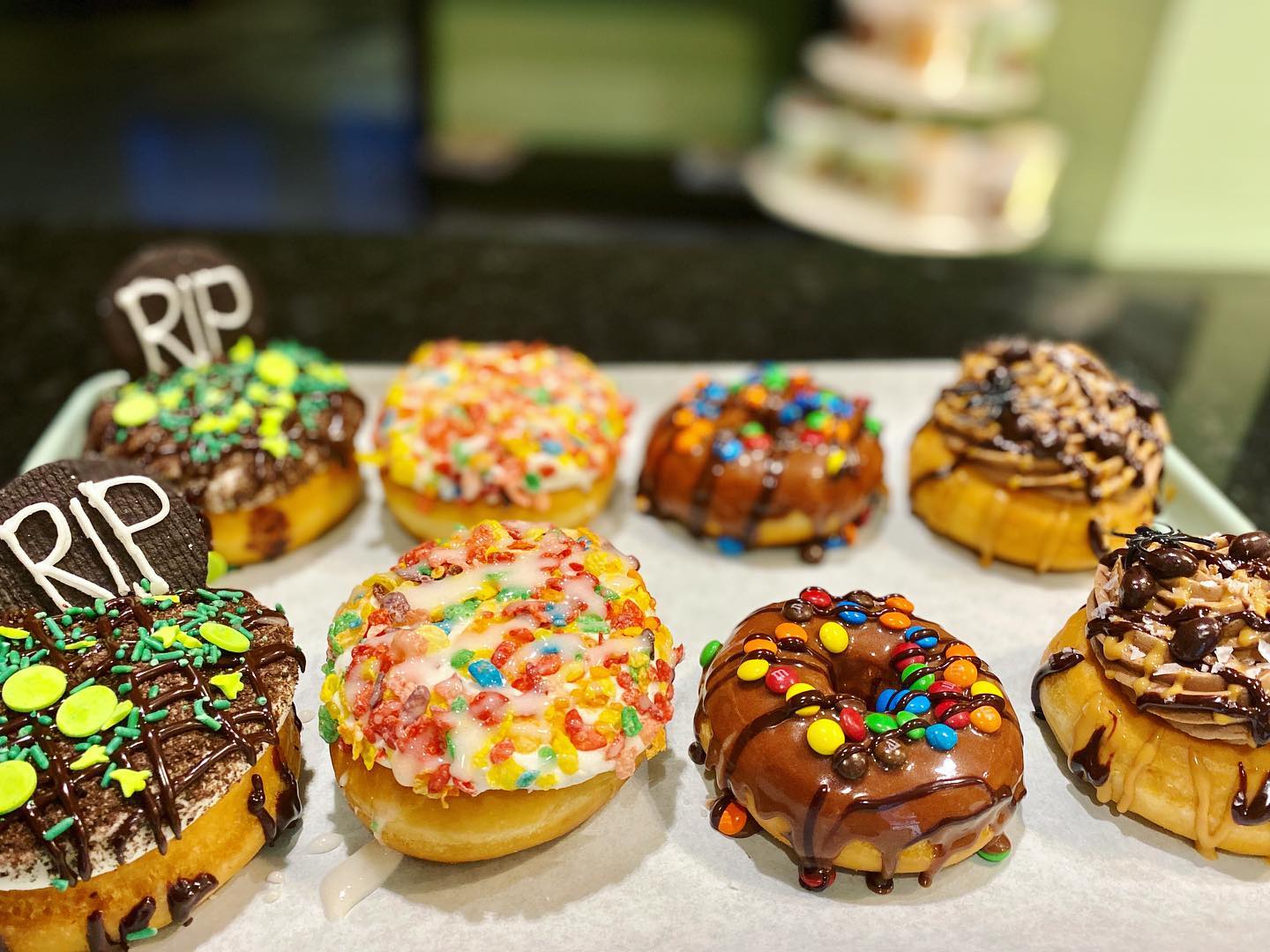 Variety of colorful donuts at Dreamcakes Cafe, dessert place in Hoover, AL