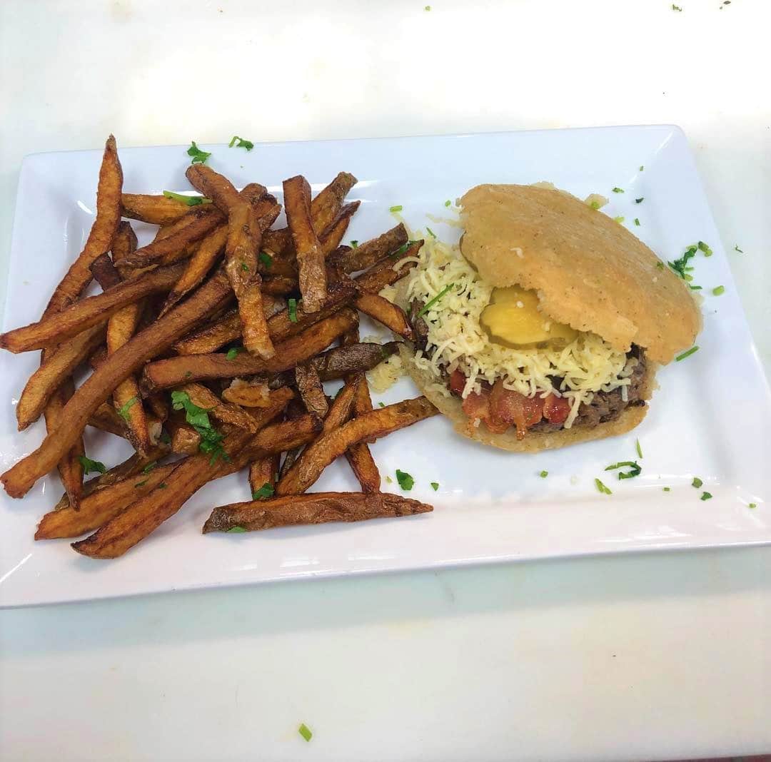 An arepa burger served with fries