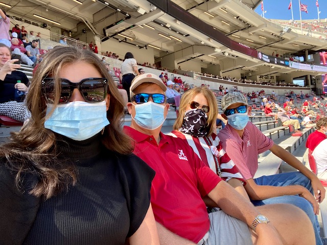 How fans are celebrating college game day across Alabama by a student 3 A family wearing masks in the stadium at an Alabama football game.