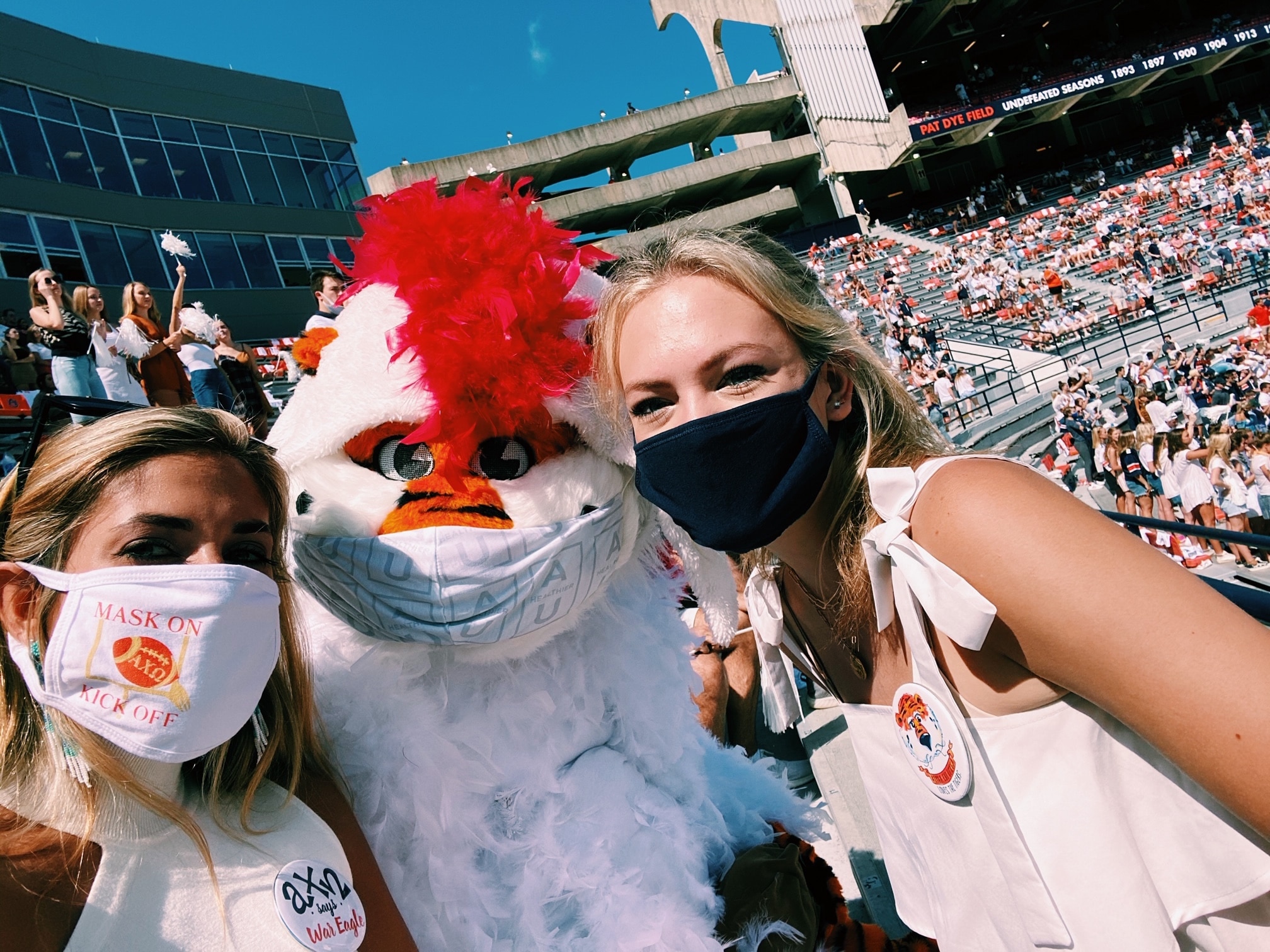 students wearing masks in the stadium at an Auburn game