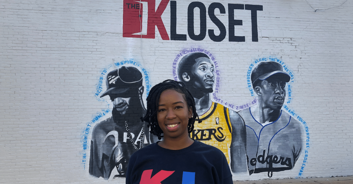 A. Nichel standing in front of Fairfield's new mural of Nipsey Hussle, Kobe Bryant and Chadwick Boseman