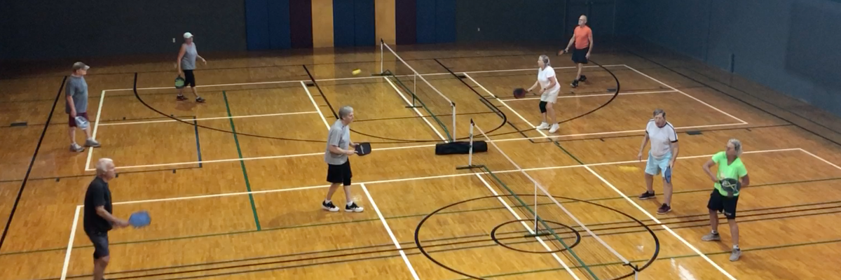Wooden courts with adults playing pickleball at Levite Jewish Community Center - Birmingham sports leagues