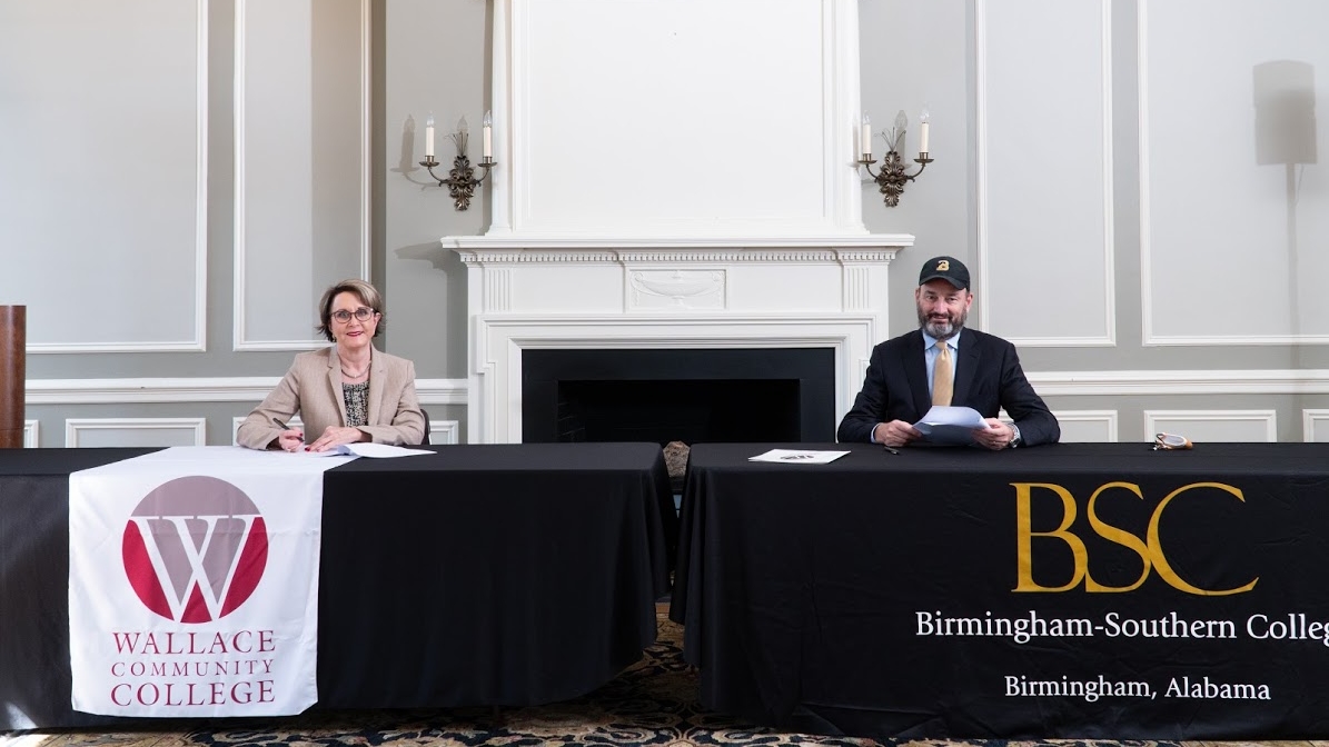 Presidents of Birmingham-Southern College and Wallace Community College sitting down to sign BSC's articulation agreements