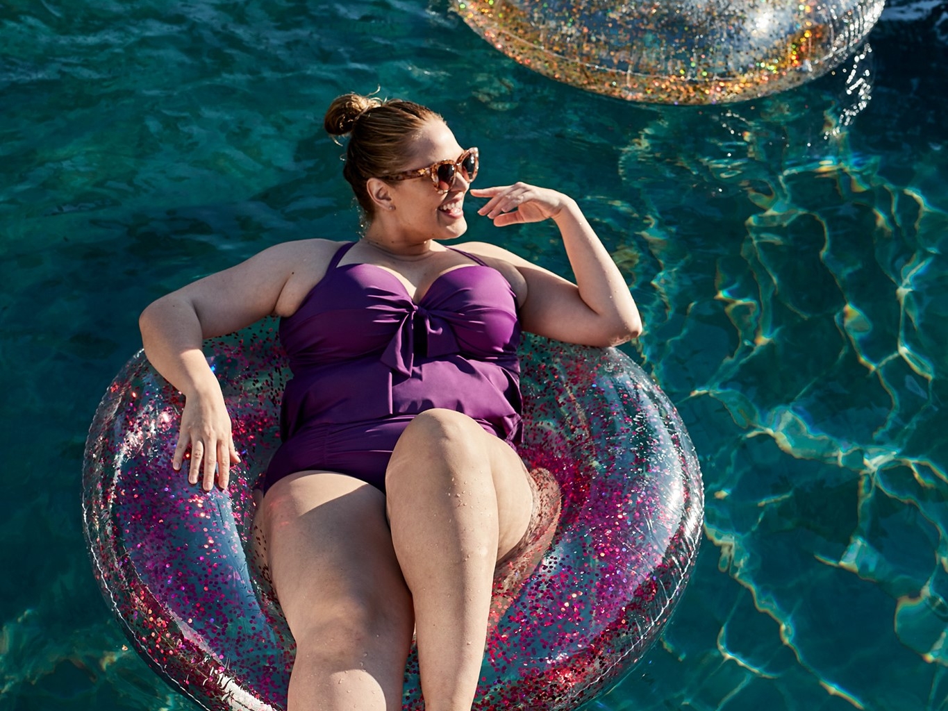 Woman wearing swimsuit on a float in the pool