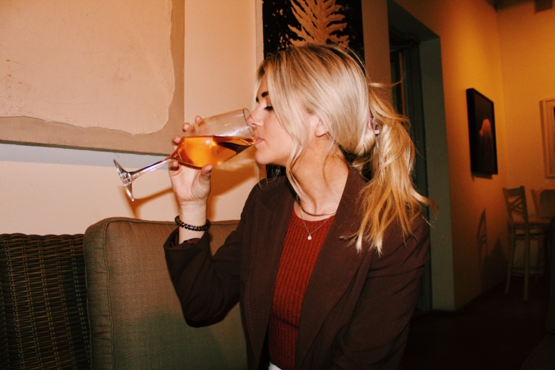 person sipping wine deals for national wine day