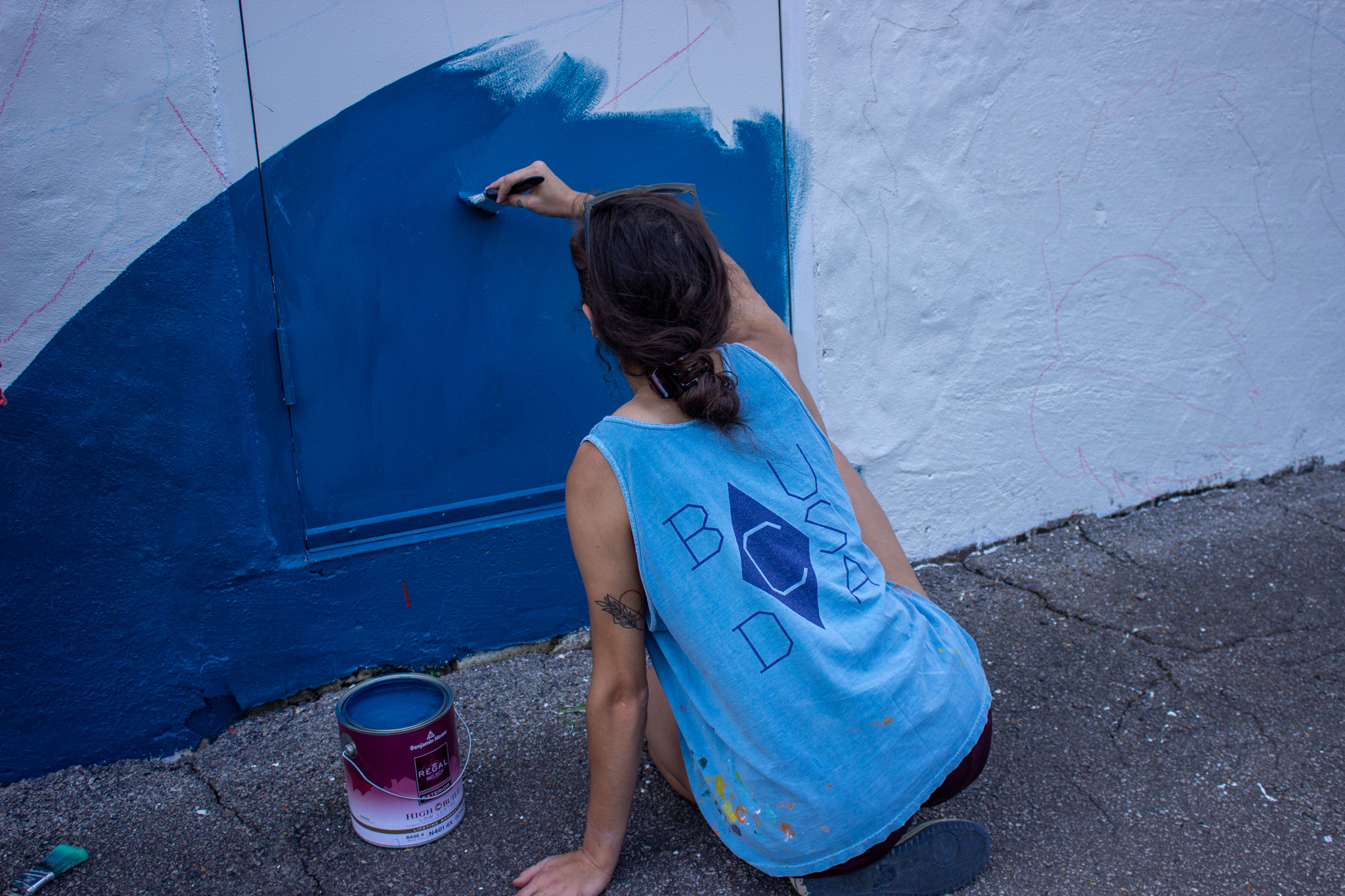 Mary Grace Tracy is working on the mural at Sozo. Photo by Libby Foster for Bham Now.
