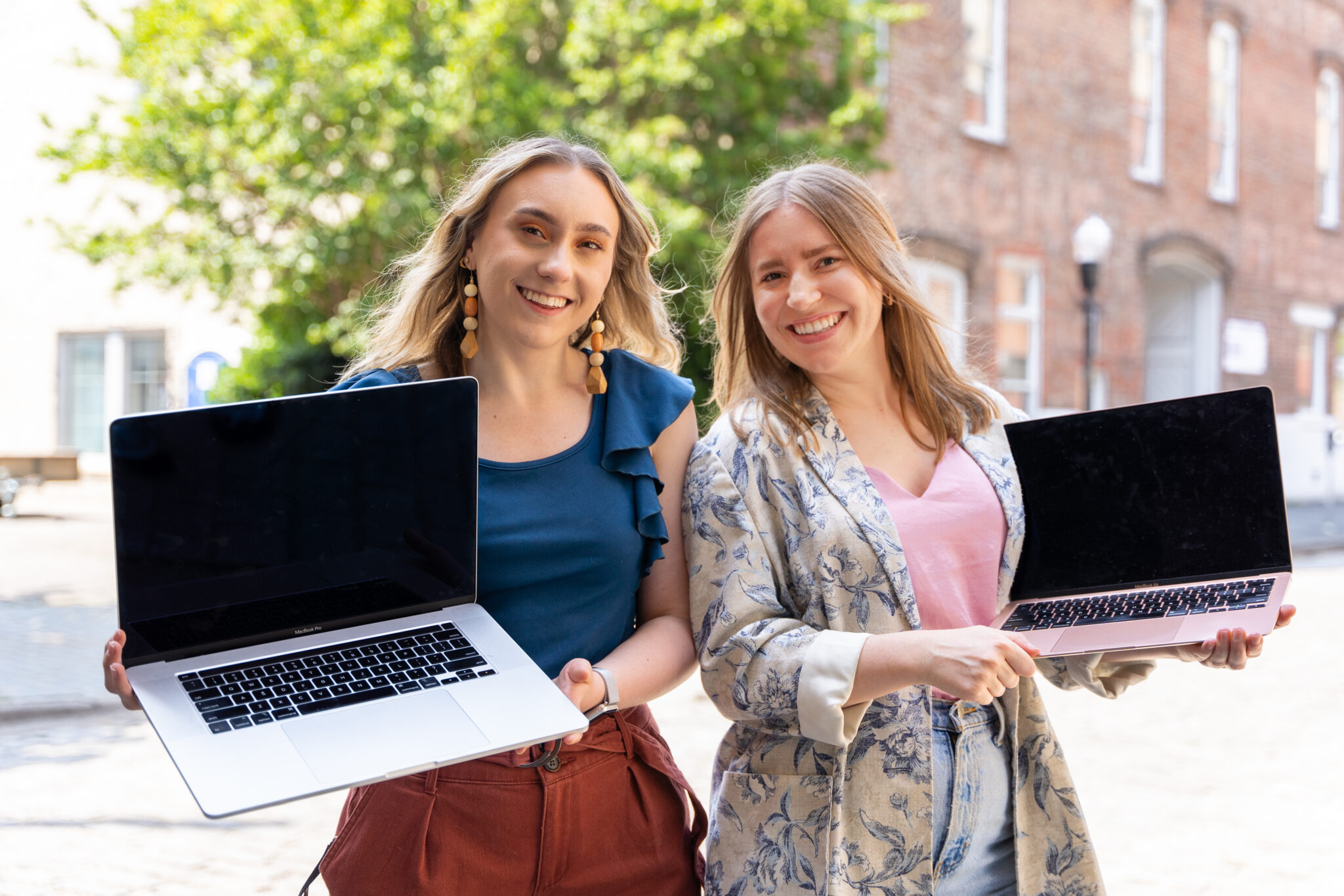 Two women holding laptops on Morris Avenue
