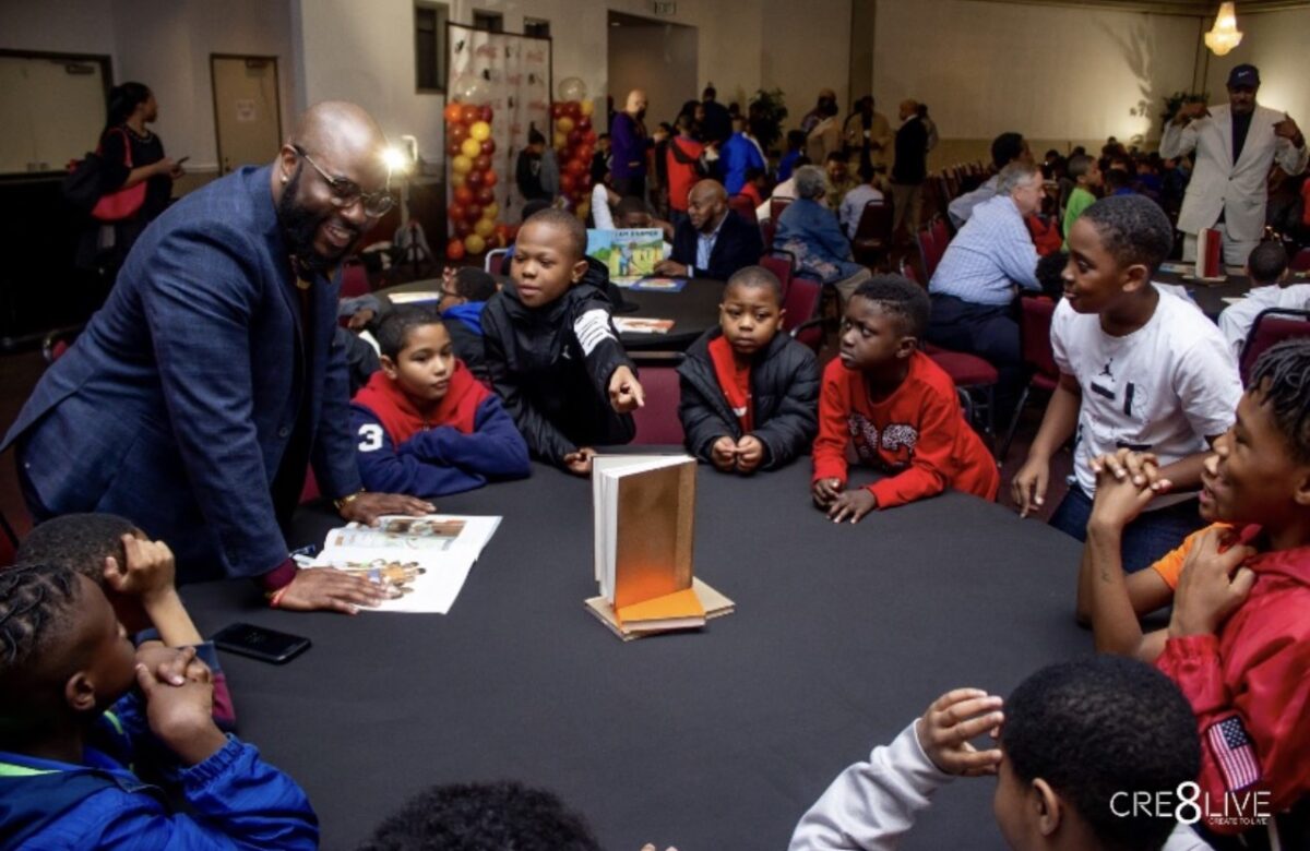 Real Men Read Man reading to several boys 13th annual Real Men Read event coming to Miles College this weekend