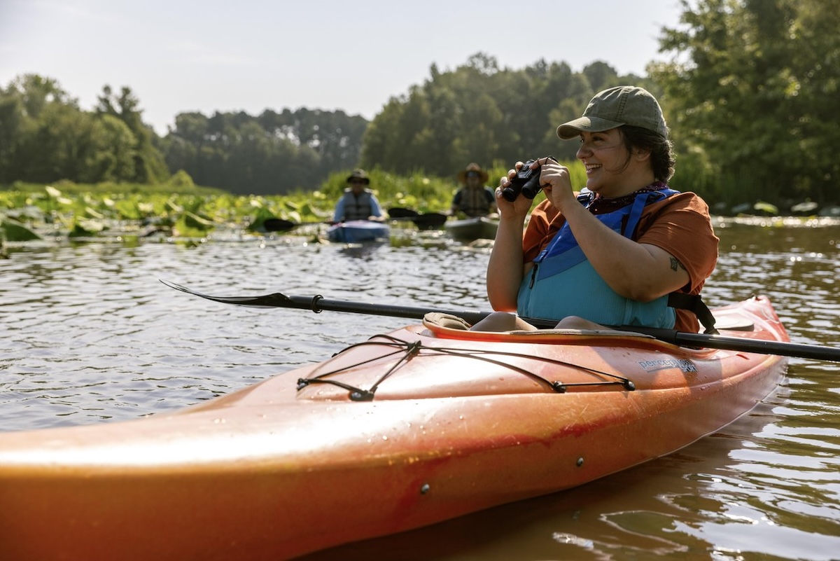 A kayaker uses binoculars to admire the nature while on an outing on Ross Barnett Reservoir in Ridgeland, Mississippi.