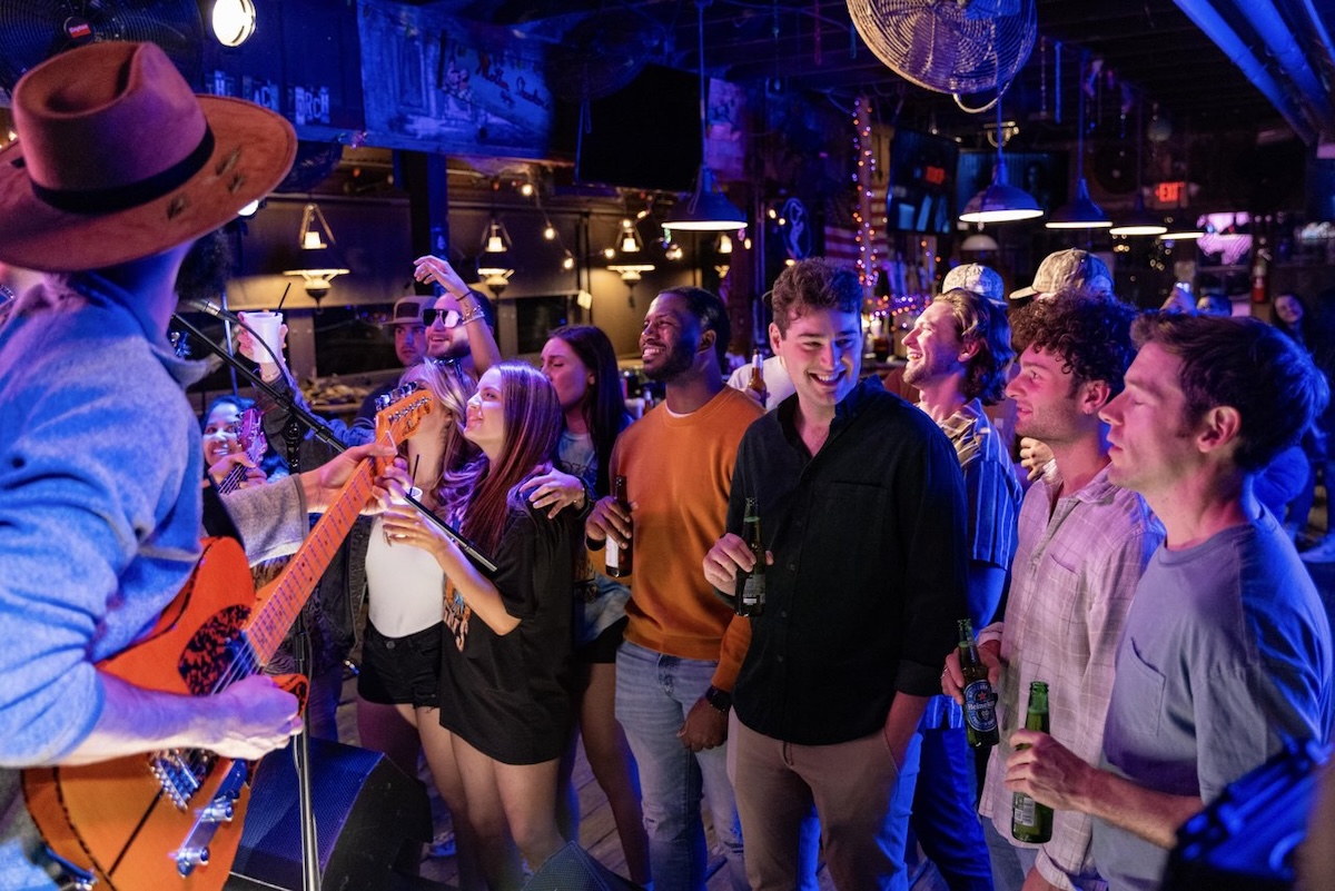A group of people enjoy live music performance at Shucker's Oyster Bar on Barnett Reservoir in Ridgeland, Mississippi.