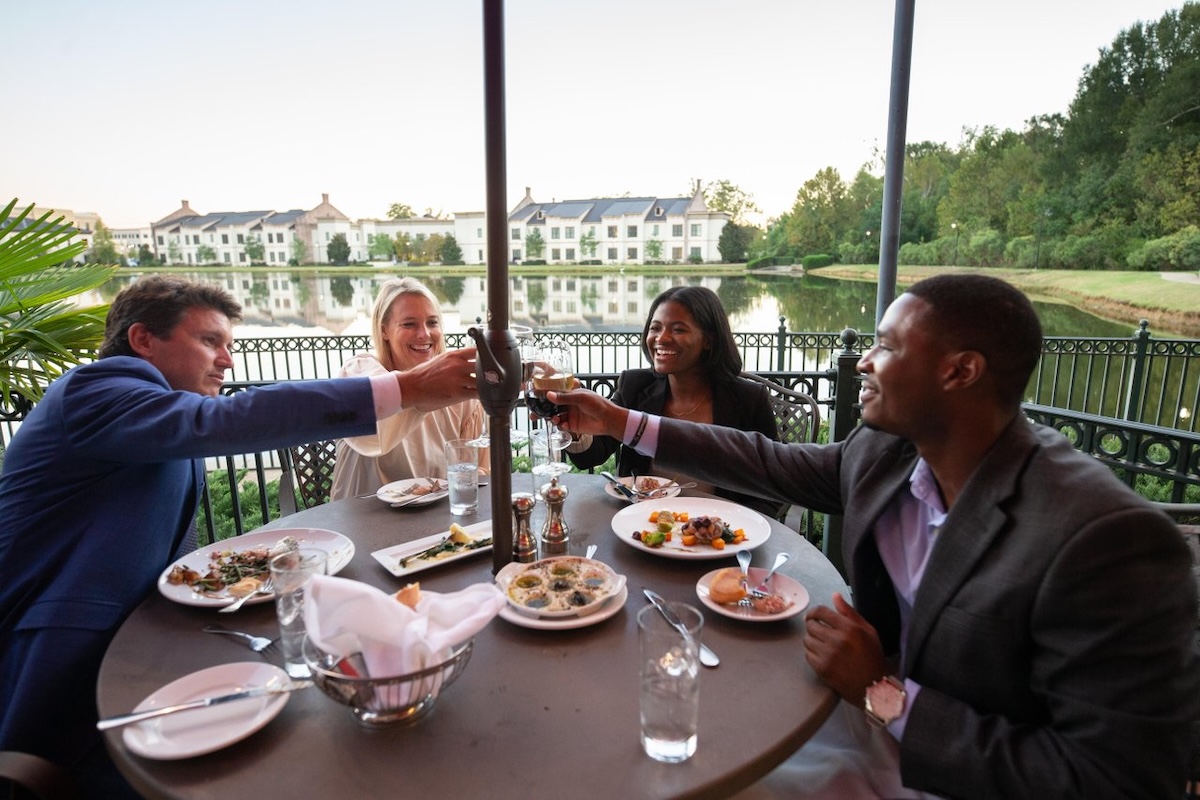 Two couples share a toast at Anjou, a French restaurant in Ridgeland, Mississippi